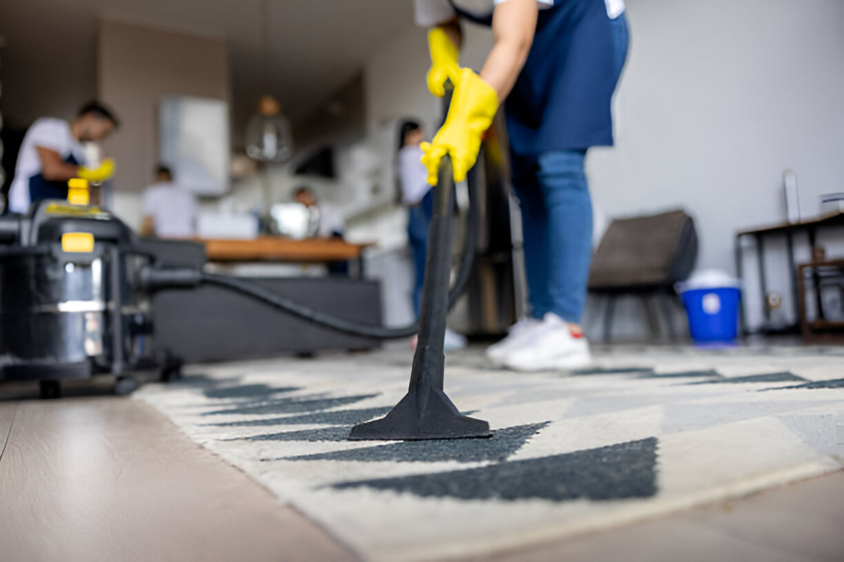 Professional cleaner vacuuming a carpet