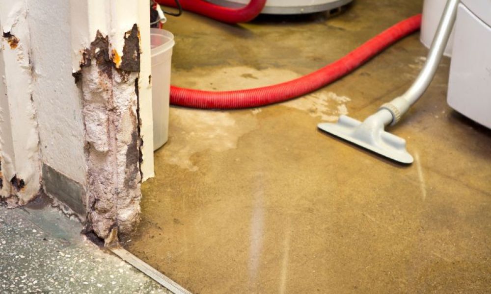 Wet basement floor being vacuumed