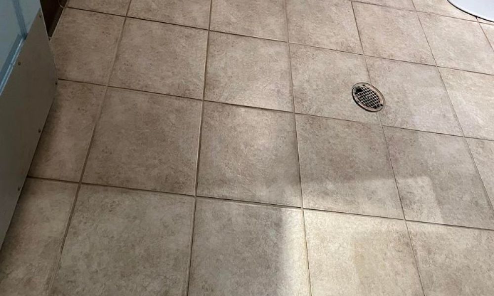Dirty floor tiles before cleaning.